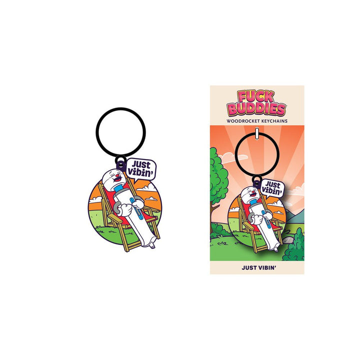 Enamel keychain featuring a cartoon wand vibrator relaxing on a chair with a "Just Vibin'" speech bubble, on branded backing card.