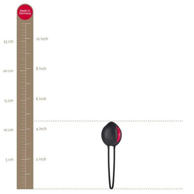 Fun Factory Smartballs Uno in white and india red shown next to a ruler for size reference, measuring about 4 inches long.