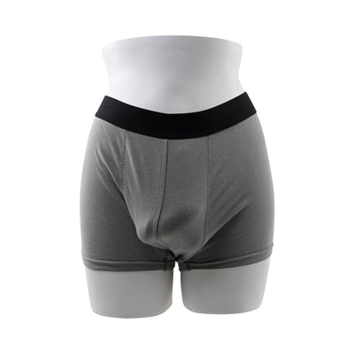 Mannequin wearing gray boxer briefs with black waistband, showing a natural-looking front pouch for packing.