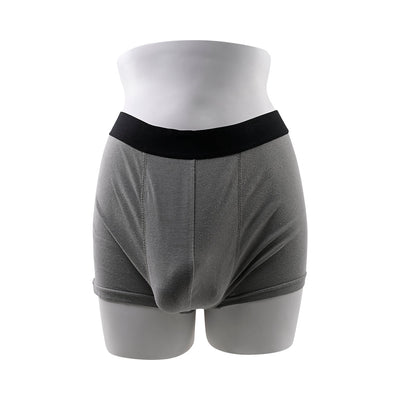 Gray boxer briefs fitted with a 4-inch silicone packer on a white mannequin torso.