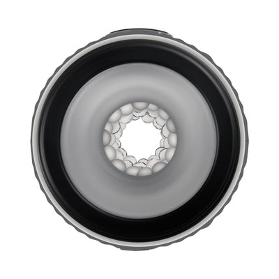 Top-down view of the Gender X Barrel Of Fun Stroker showing the soft, textured inner channel with nubbed feelers and black outer rim.
