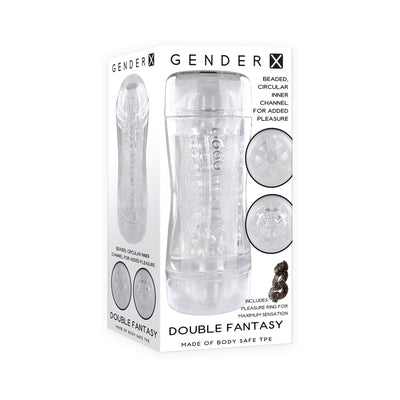 Clear dual-ended Gender X Double Fantasy stroker with beaded inner channel, shown in its white packaging with product details.