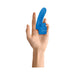 Hand holding a blue Gender X Flick It Finger Vibrator designed for targeted stimulation with a flexible, textured shaft.