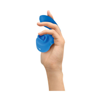 Hand holding a blue Gender X Flick It Finger Vibrator with a flexible, textured design and ergonomic shape.