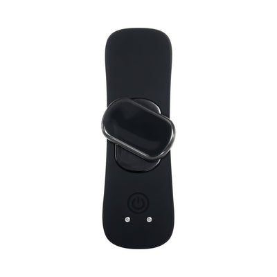 Compact black magnetic vibe resting on a sleek black remote control with power button and LED indicators.