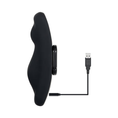 Black curved silicone undie vibe with magnetic remote and USB charging cable on white background.