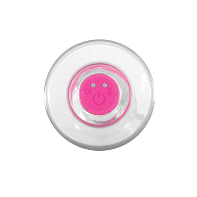 Top view of clear vibrating toy showing pink power button and transparent curved design.