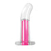 Clear curved vibrating toy with bright pink inner bullet and flared base on white background.