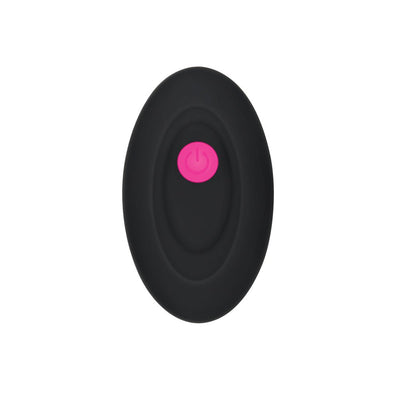 Black oval remote control with a central pink power button for Gender X Pink Paradise Rechargeable vibrator.