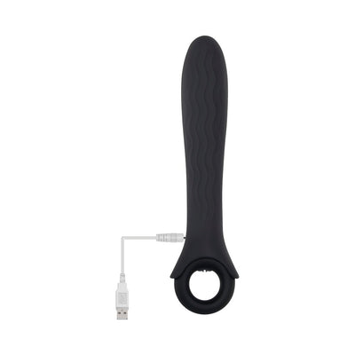 Black silicone vibrator with wavy texture and ring handle, shown with USB charging cable attached.