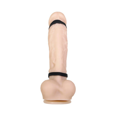 Black triple ring vibrating penis sheath displayed on a flesh-toned model with textured silicone material.