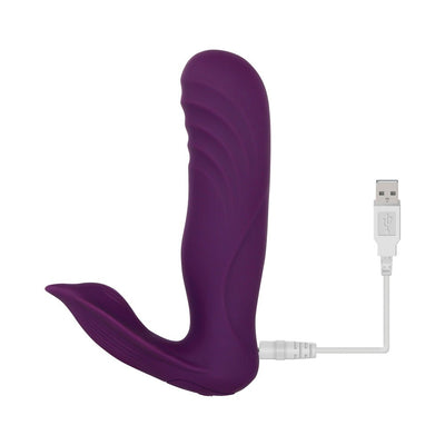 Purple dual-motor wearable vibrator with textured shaft and stingray-shaped external stimulator, shown with USB charging cable.