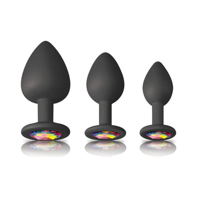 Set of three black silicone spade-shaped trainers with colorful jewel bases in small, medium, and large sizes.
