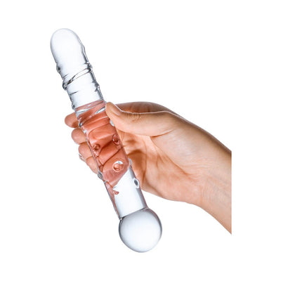 Hand holding a clear glass dildo with spiraled ridges and rounded nubs, designed for targeted internal stimulation.