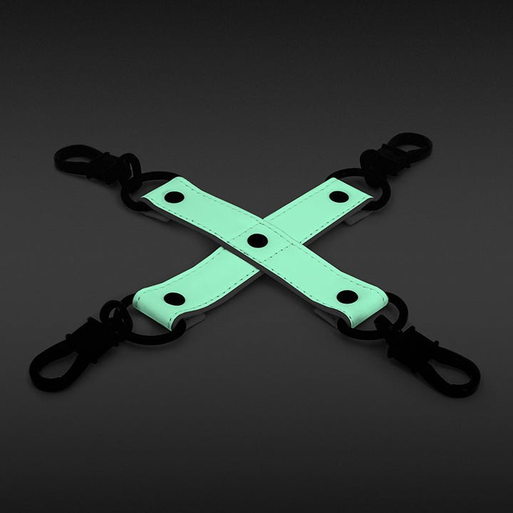 Glow-in-the-dark green PU leather bondage hog tie with black clips on a dark background