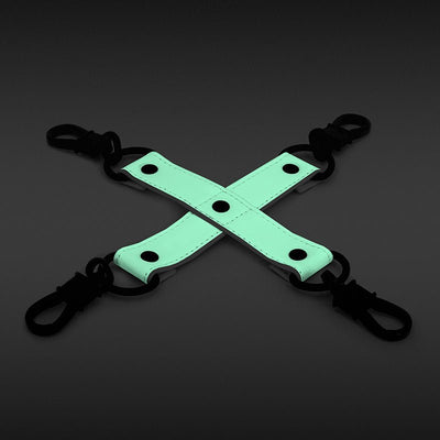 Glow-in-the-dark green PU leather bondage hog tie with black clips on a dark background