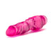 Pink translucent realistic vibrator with textured shaft and twist dial base on white background