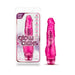 Pink realistic vibrator with clitoral stimulation, glow-in-the-dark feature, and multi-speed vibration control shown in packaging and standalone.