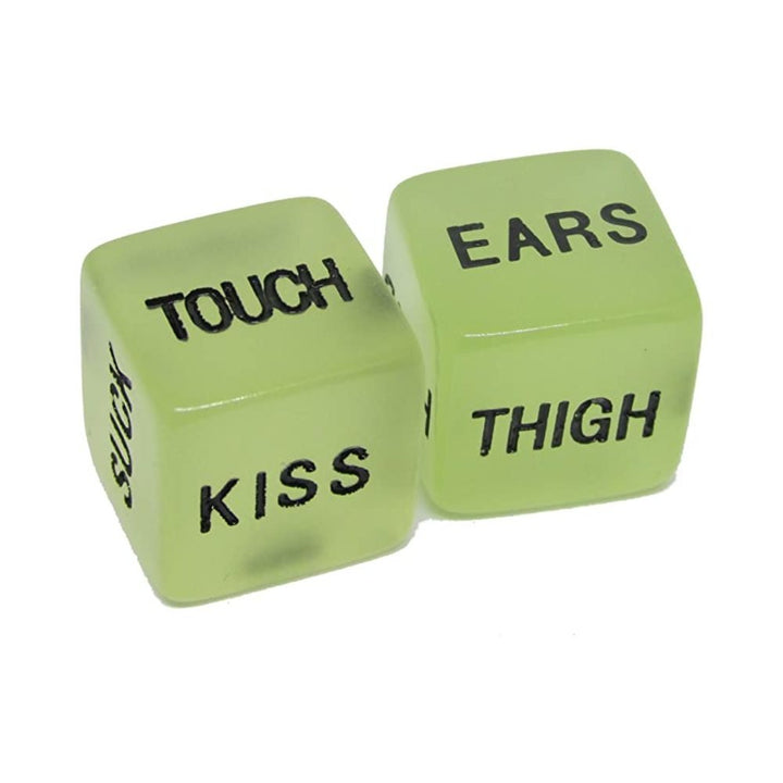 Glow in the dark erotic dice set with Spanish words for playful intimate actions and body parts.
