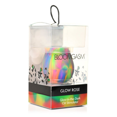 Rainbow-colored Glow Rose clit stimulator in clear packaging with black and floral accents, labeled Glow-in-the-Dark Clit Stimulator.