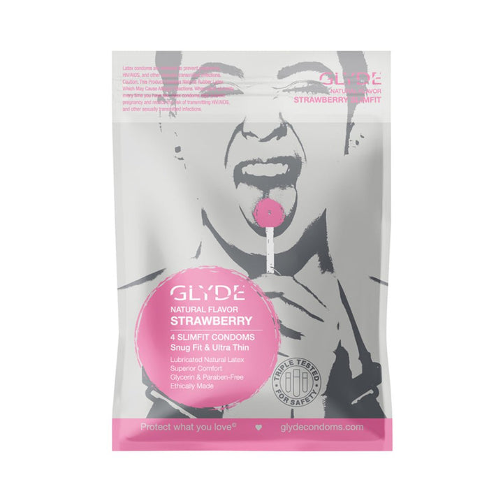 Glyde Slimfit Natural Strawberry flavored condom 4-pack in silver and pink packaging with artistic face and lollipop design.