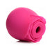 Pink silicone clitoral suction stimulator shaped like a blooming rose with a central suction opening.