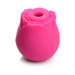 Pink silicone clitoral vibrator shaped like a blooming rose with a central suction opening.