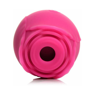 Pink silicone clitoral suction stimulator shaped like a blooming rose with a central suction hole.