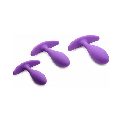 Set of three violet silicone plugs in small, medium, and large sizes with curved bases for comfort and control.