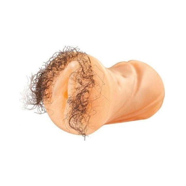 Beige realistic travel-sized masturbator with detailed hair fibers around the opening on a white background.