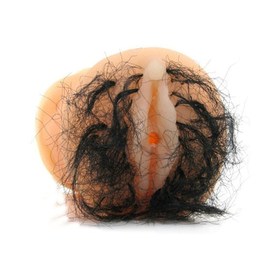 Beige realistic travel masturbator with detailed black hair fibers around the opening, compact and waterproof design.