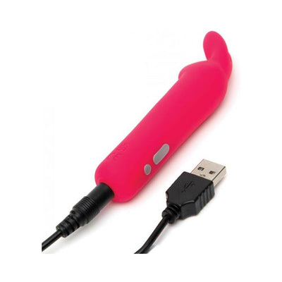 Pink silicone Happy Rabbit rechargeable bullet vibrator with flexible bunny ears and USB charging cable attached.