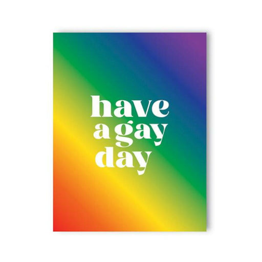 Greeting card with a vibrant rainbow gradient background and bold white text reading "have a gay day" on the front.