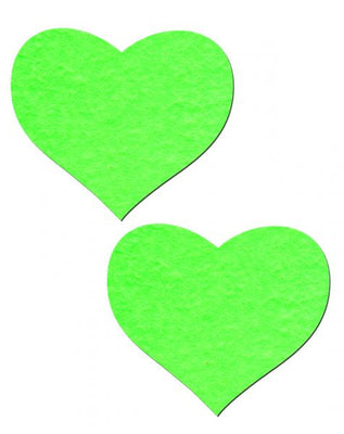 Pair of neon green heart-shaped glow in the dark adhesive pasties on white background.