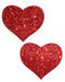 Pair of red glitter heart-shaped adhesive pasties with sparkling finish on white background