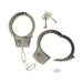 Silver heavy metal handcuffs with chain and two vintage-style release keys on white background.