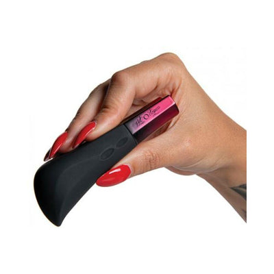 Hand holding a sleek black and plum Hot Octopuss Kurve G-spot vibrator with red nail polish on white background.