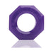 Purple octagonal Humpx cockring made from flexible material with embossed branding on a reflective surface.