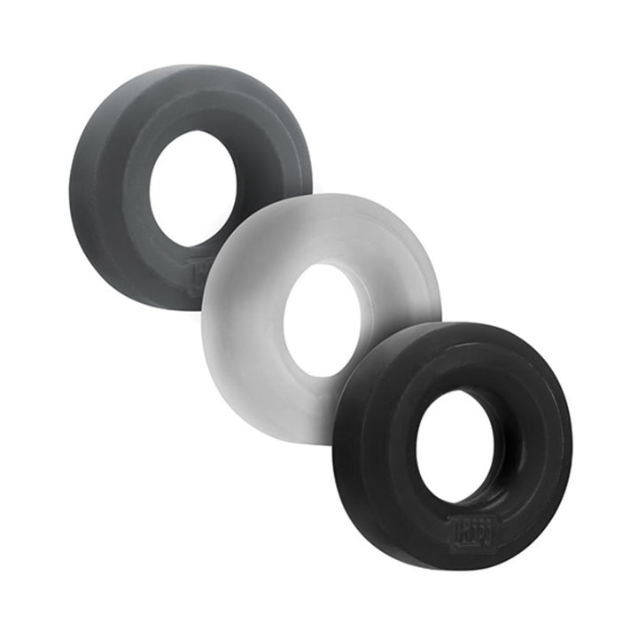 Three Hunkyjunk Huj3 c-rings in black, gray, and white arranged side by side on a white background.