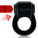 Black rubbery cockring with "REVERB" embossed, shown with a red bullet vibrator beside it and an arrow indicating insertion.