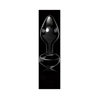 Sleek black hand-blown glass butt plug with tapered tip and ergonomic base on a reflective black surface.