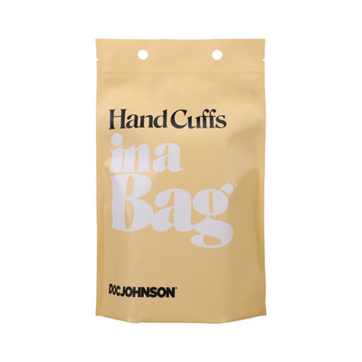 Beige resealable pouch packaging for In A Bag black handcuffs by Doc Johnson with bold black and white text.