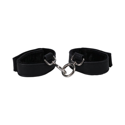 Black vegan leather handcuffs with soft velvet lining and metal connectors, designed for comfortable restraint play.