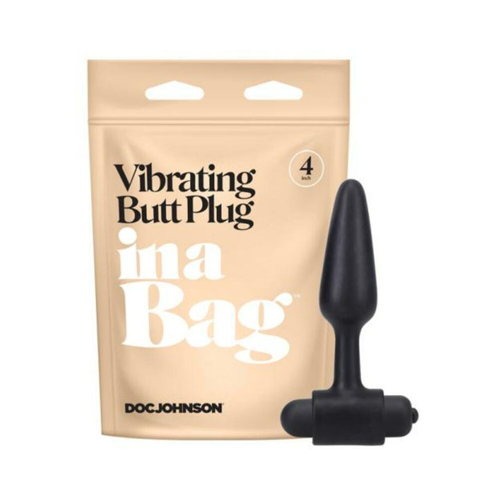 Black 4-inch tapered vibrating butt plug with bullet vibrator next to beige resealable packaging pouch.