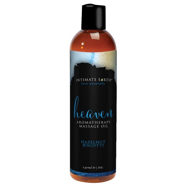 Bottle of Intimate Earth Heaven Hazelnut Biscotti aromatherapy massage oil with black label and blue accents, 8oz size.
