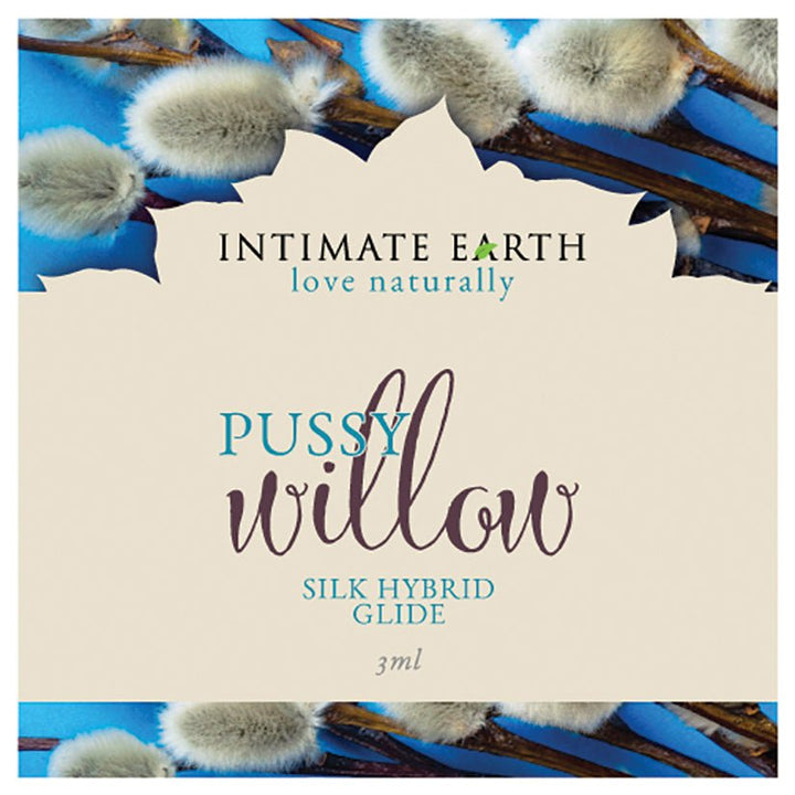 Intimate Earth Pussy Willow Silk Hybrid Glide 3ml foil packet with soft pussy willow branches background