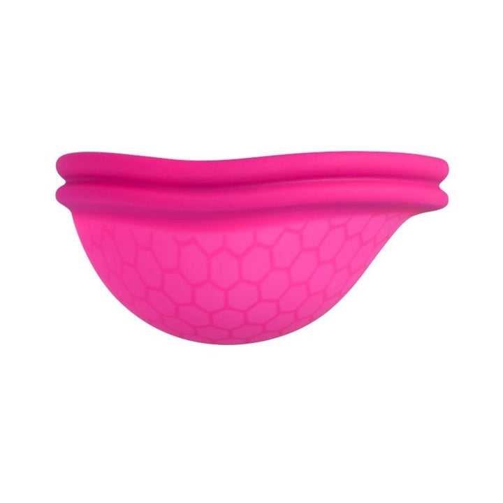 Pink Intimina Ziggy menstrual cup with textured hexagonal pattern and flat-fit design for comfort.