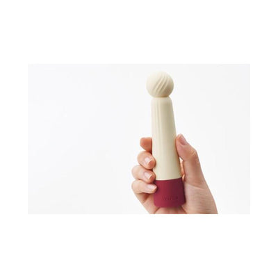 Hand holding the Iroha Rin Akane Massager by Tenga with a soft spherical tip and maroon base against a white background.