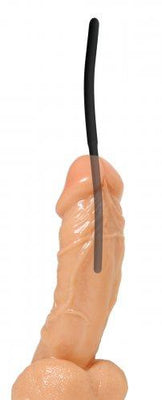 Black silicone urethral sound inserted into a flesh-toned silicone model for demonstration.