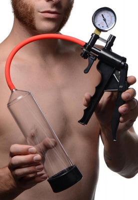 Man holding a red and black penis pump with pressure gauge and clear 9-inch cylinder.